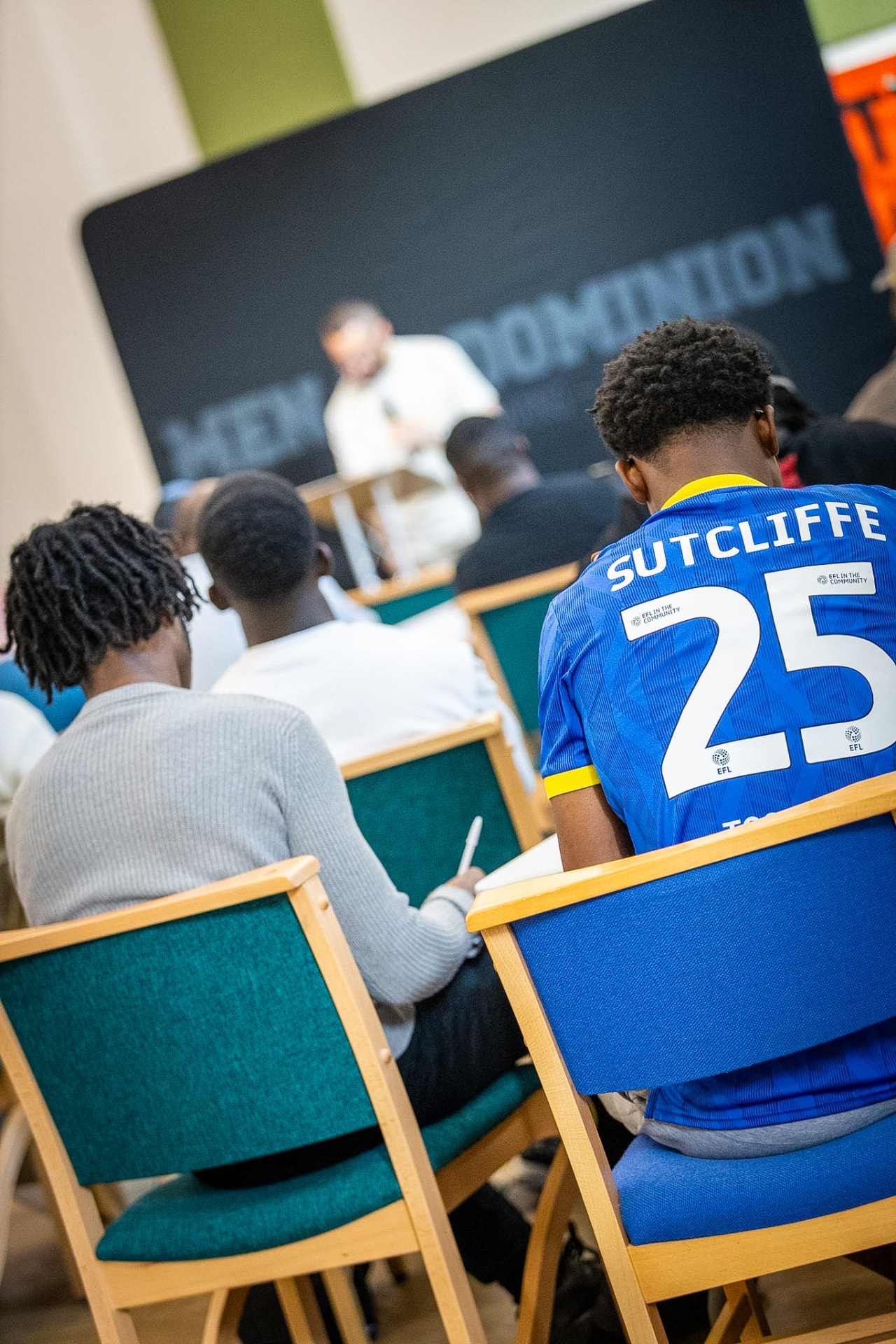 Men seated and listening together during a Made for Dominion session